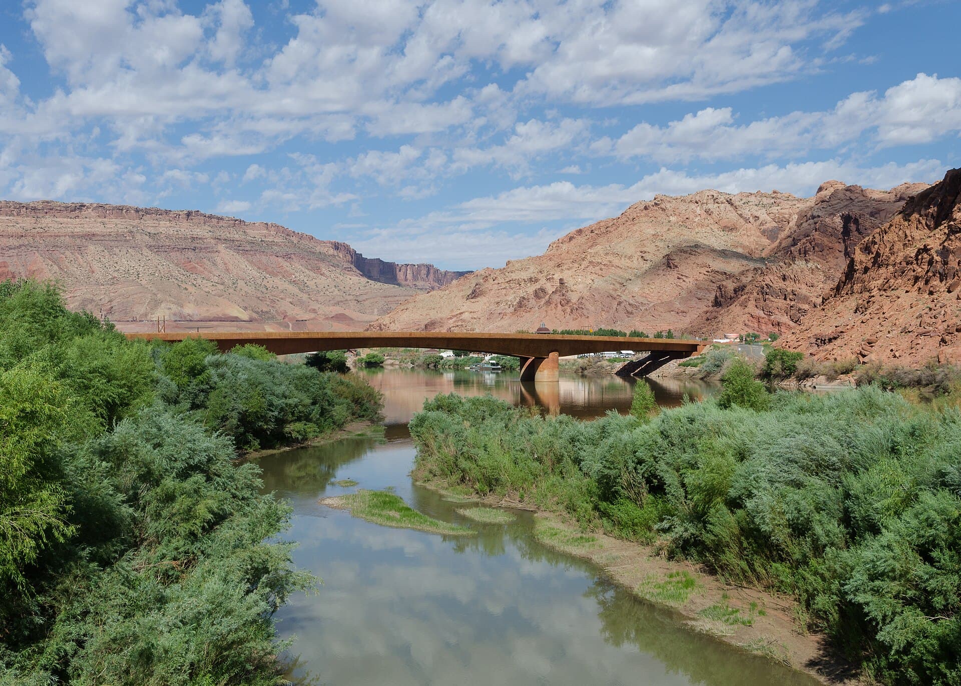 The Colorado River winding beneath red rock cliffs near Moab, Utah
