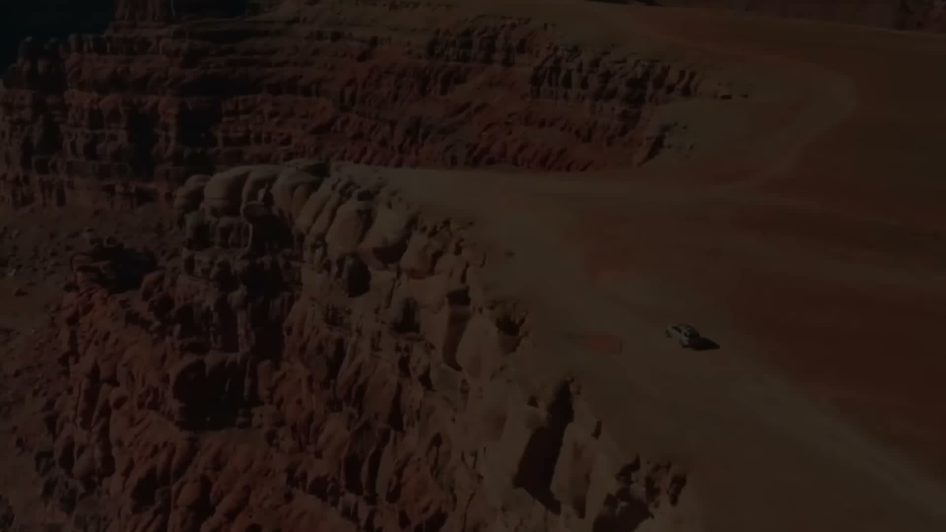 Aerial view of a 4x4 on a backcountry road above the canyons of Canyonlands National Park